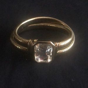 Gold tone white crystal cobra style bracelet